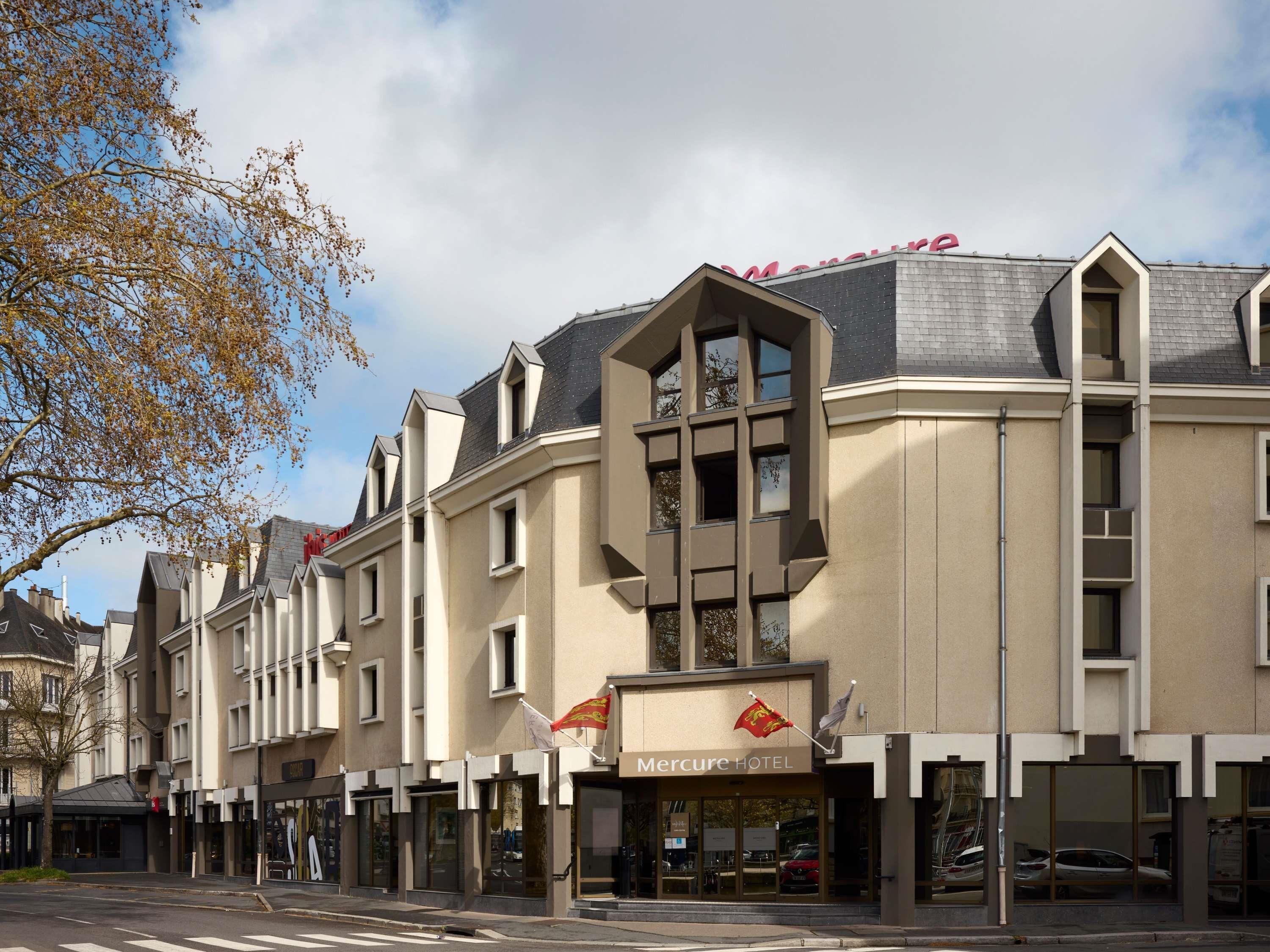 A hotel with a modern facade, multiple balconies, and a prominent Mercure logo.