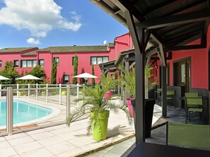 Seasonal outdoor pool, open 10:00 AM to 10:00 PM, pool umbrellas