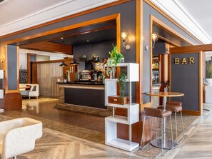 A modern bar area with a counter, bar stools, and a sign that reads "BAR". - Novotel Bristol Centre (Bristol)