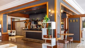 A modern bar area with a counter, bar stools, and a sign that reads "BAR". - Novotel Bristol Centre (Bristol)
