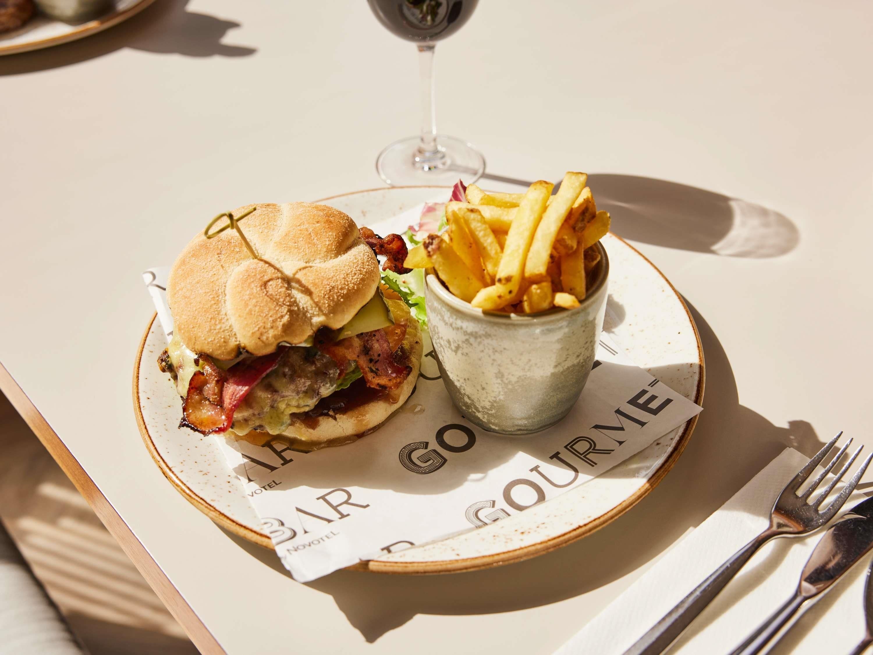 A meal with a burger and fries on a plate with a menu.