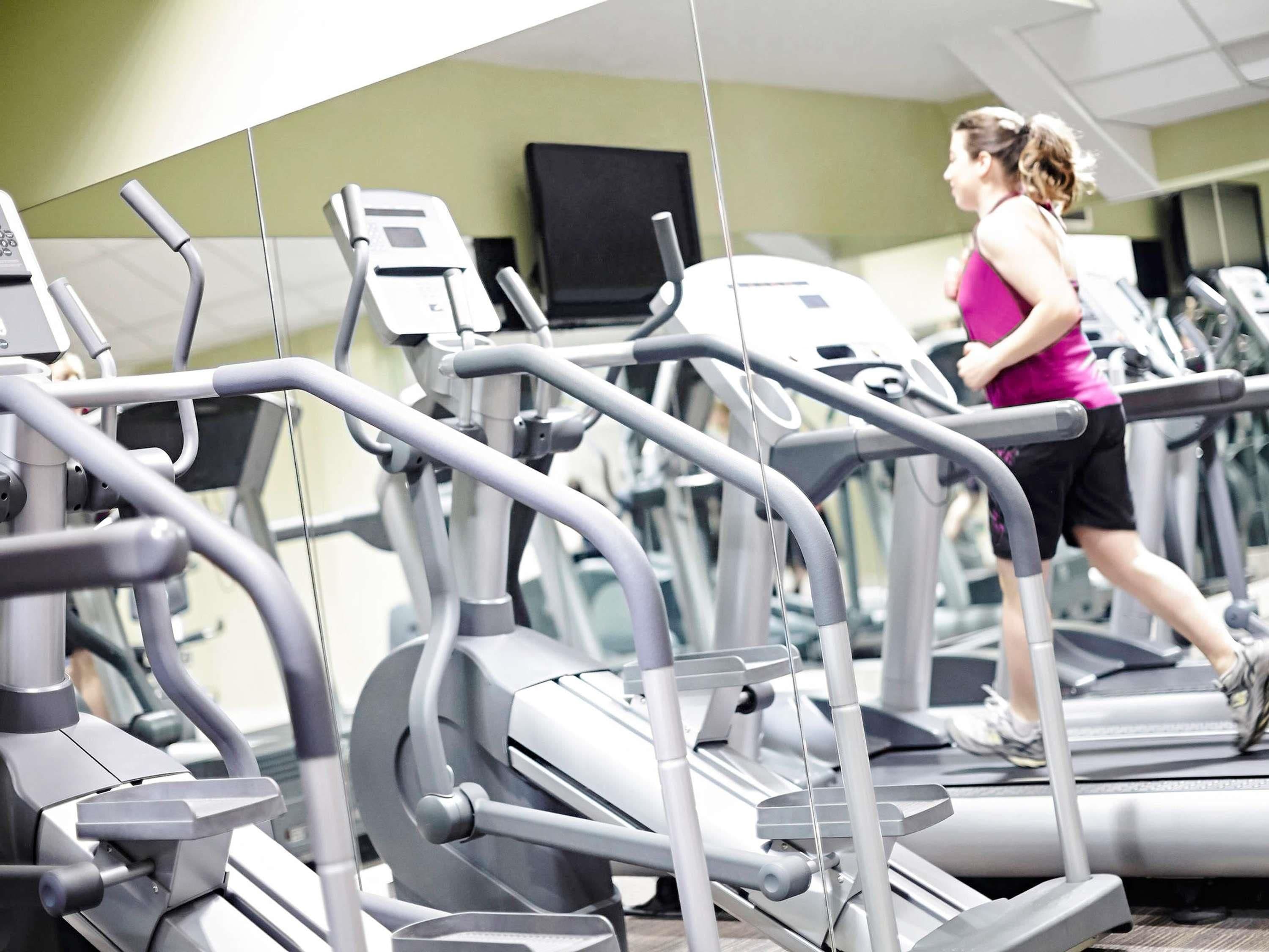 A gym with treadmills and exercise equipment.