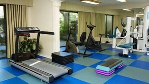 A gym with treadmills, stationary bikes, and weight machines.