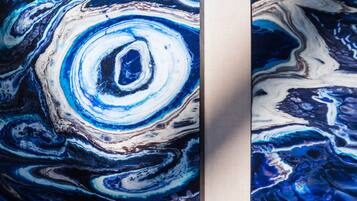 A close-up of a marble-like surface with swirling patterns.