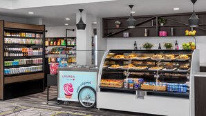 A food kiosk with a gelato display and a variety of packaged snacks. - Hyatt Regency Princeton (Princeton)