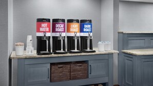 A coffee station with four dispensers labeled "Hot Water," "Decaf Roast," "Light Roast," and "Dark Roast." - Hampton Inn Pittsburgh/Greentree (Pittsburgh)