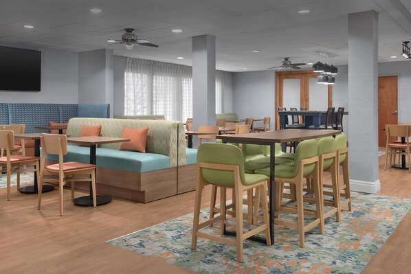 Relax in a spacious room with a central dining area and comfortable seating.