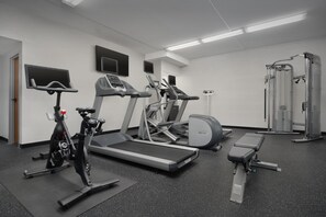 Stay fit and entertained in our well-equipped gym with exercise machines, treadmills, and a weight bench.