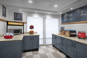 Guests can enjoy a fully equipped kitchen with a microwave, coffee machine, and ample counter space.