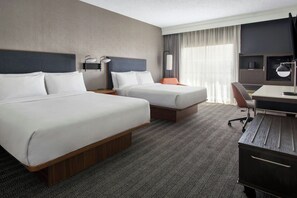 A hotel room with two beds, a desk, a chair, and a TV. - Courtyard Syracuse Carrier Circle (East Syracuse)