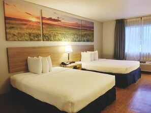 A hotel room with two beds, a nightstand with a lamp, a painting of a sunset, and a window with curtains. - Days Inn by Wyndham Osage Beach Lake of the Ozarks (Osage Beach)