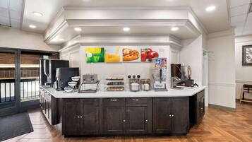 A modern kitchen with a central island, built-in appliances, and a breakfast bar.