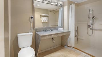 Un baño moderno con inodoro, lavamanos y ducha.