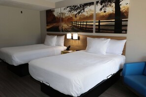 A hotel room with two beds, a nightstand, and a wall-mounted lamp. - Days Inn by Wyndham Farmville (Farmville)