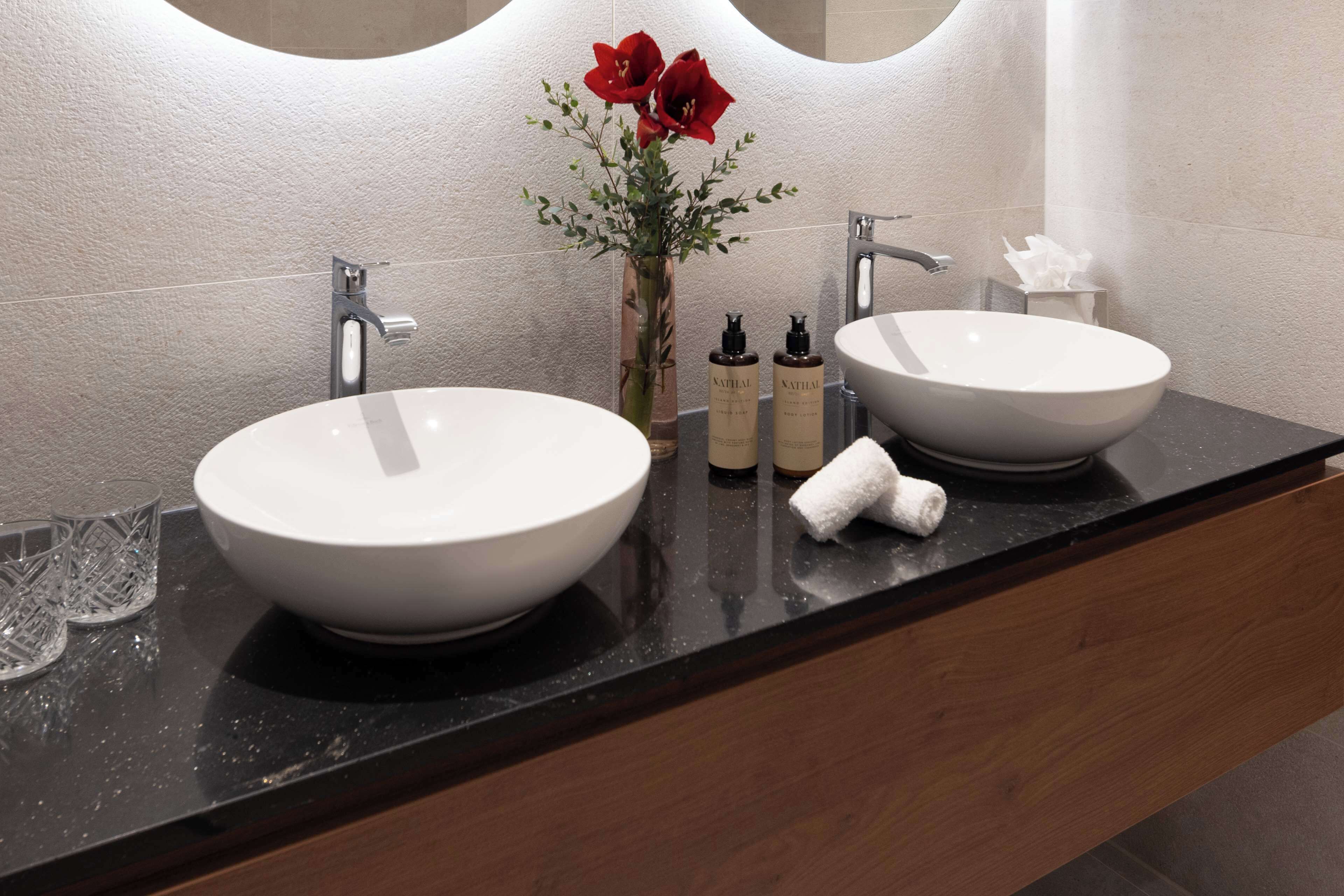 eco-friendly toiletries, hair dryer, slippers, towels