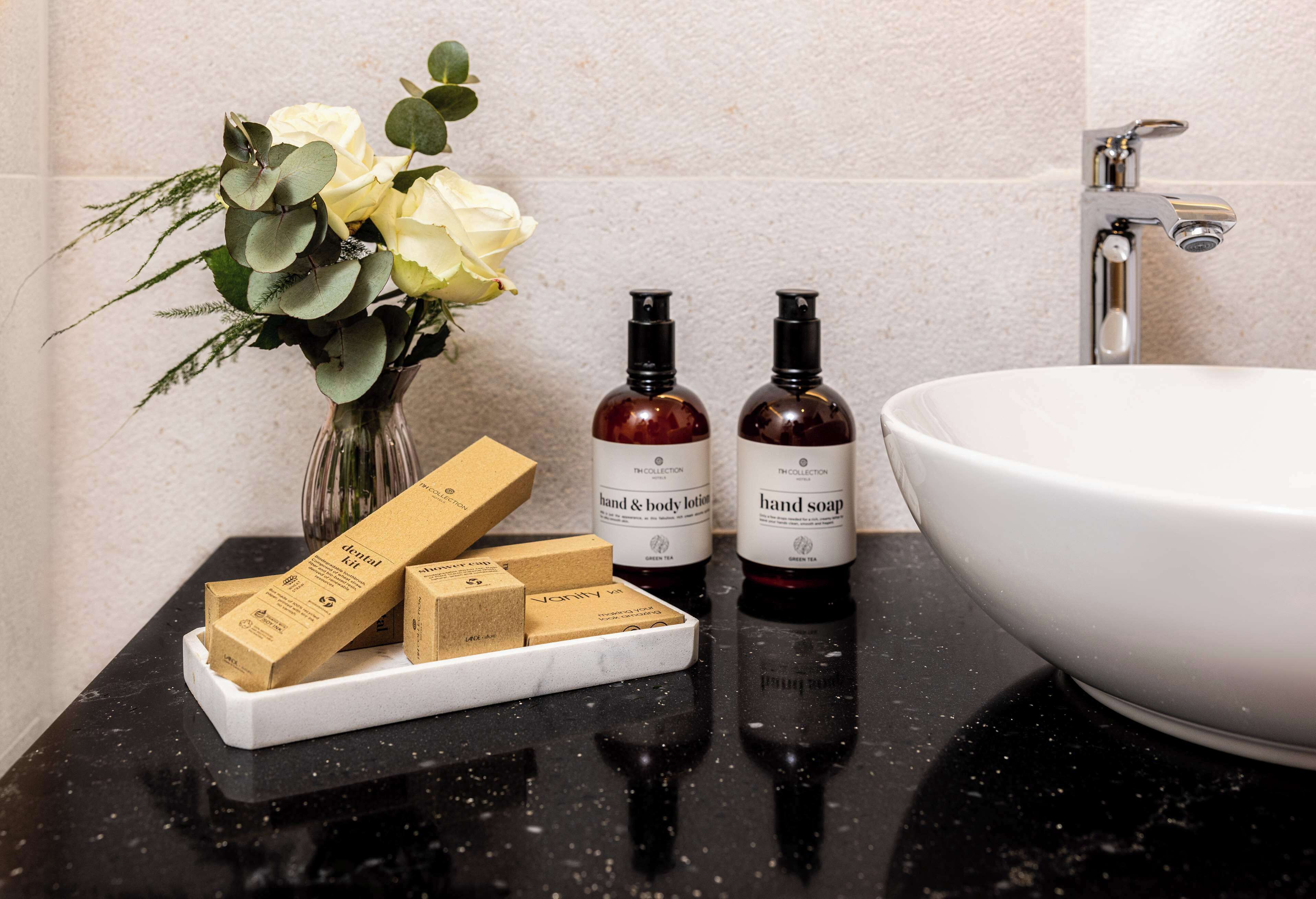 eco-friendly toiletries, hair dryer, slippers, towels