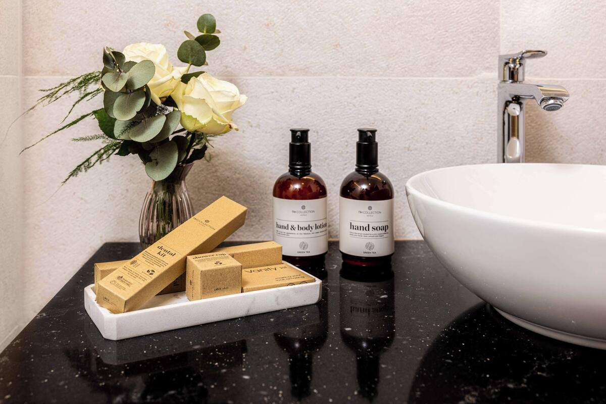 eco-friendly toiletries, hair dryer, slippers, towels