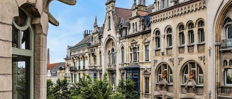 A historic building with ornate architectural details, including arched windows and decorative stonework.