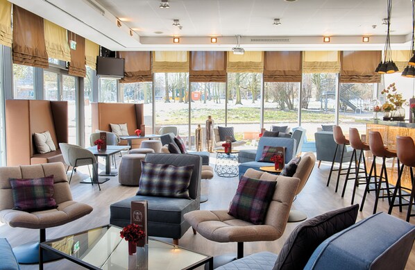 Relax in our stylish lobby with sofas, armchairs, and a bar area.
