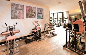 Stay fit and active in our well-equipped gym featuring exercise machines and large windows.
