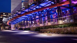 A modern building with a covered outdoor area featuring seating and a glass facade. - Wyndham Atlanta Buckhead Hotel & Conference Center (Atlanta)