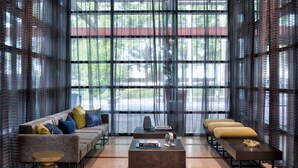 A modern lounge area with a sofa, two side tables, and a coffee table. - Wyndham Atlanta Buckhead Hotel & Conference Center (Atlanta)