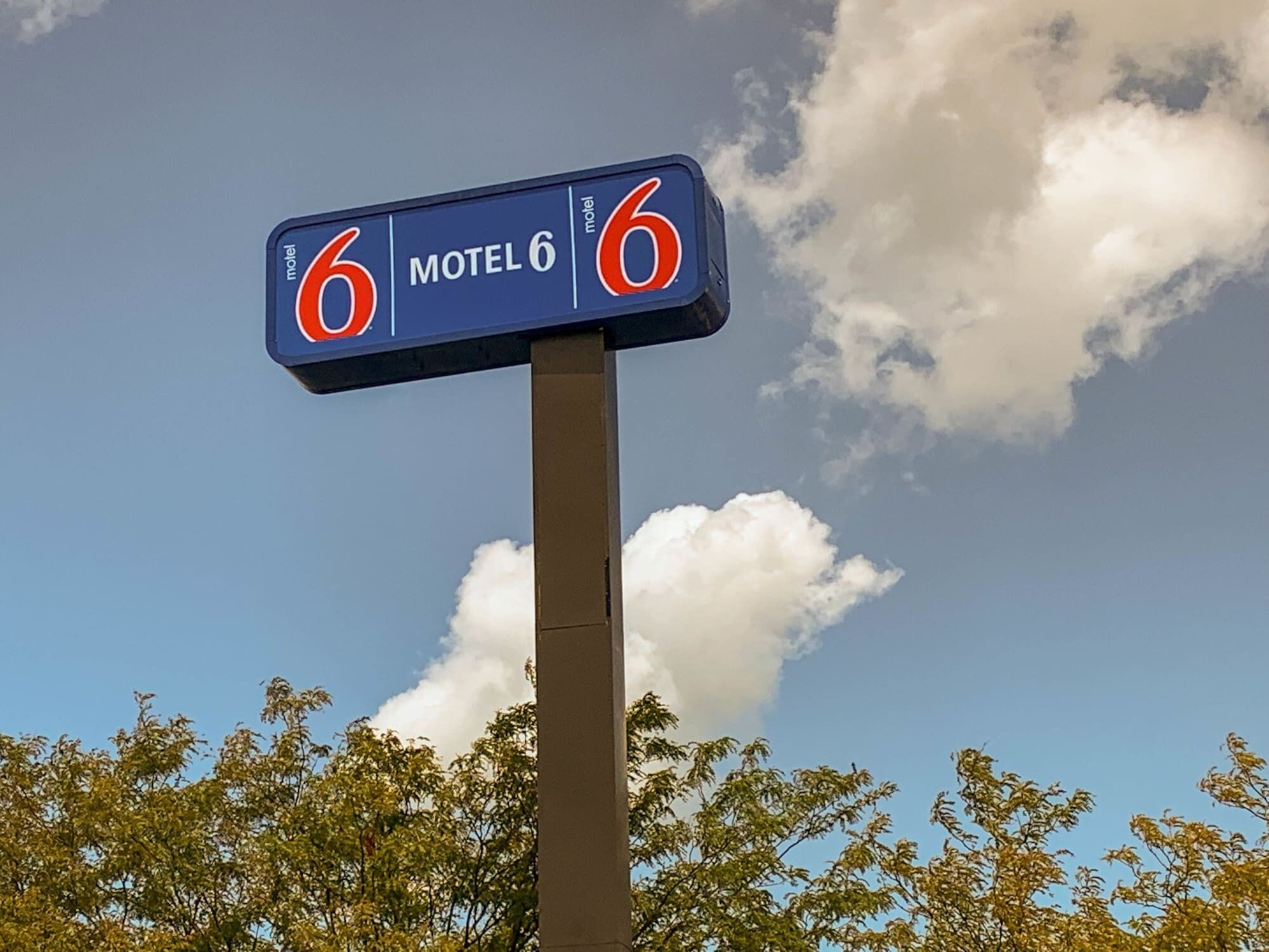Een motelbord met het nummer 6 en de naam 'Motel 6'.