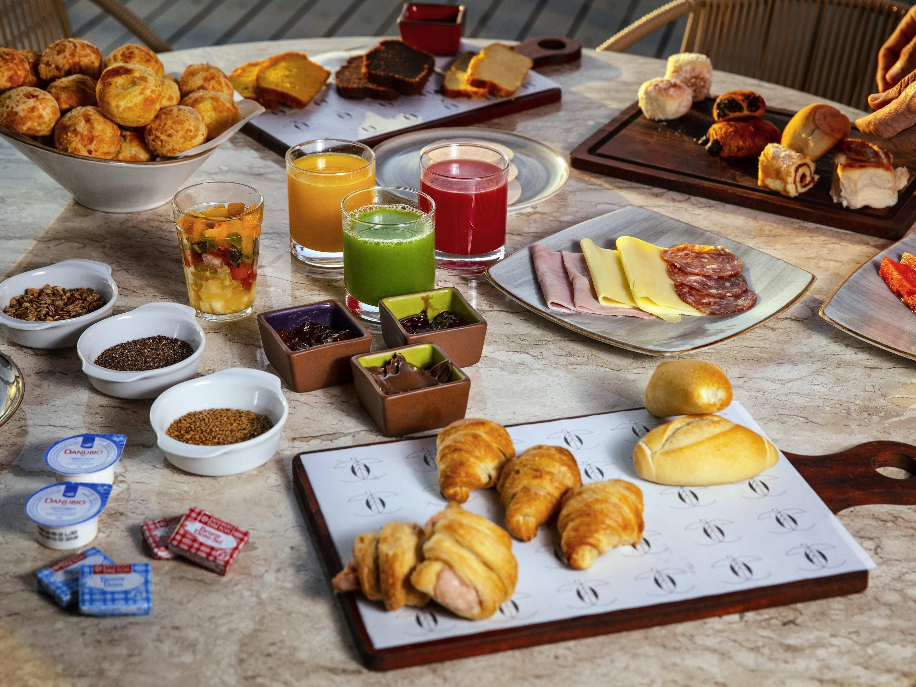 A breakfast buffet with various foods and beverages.