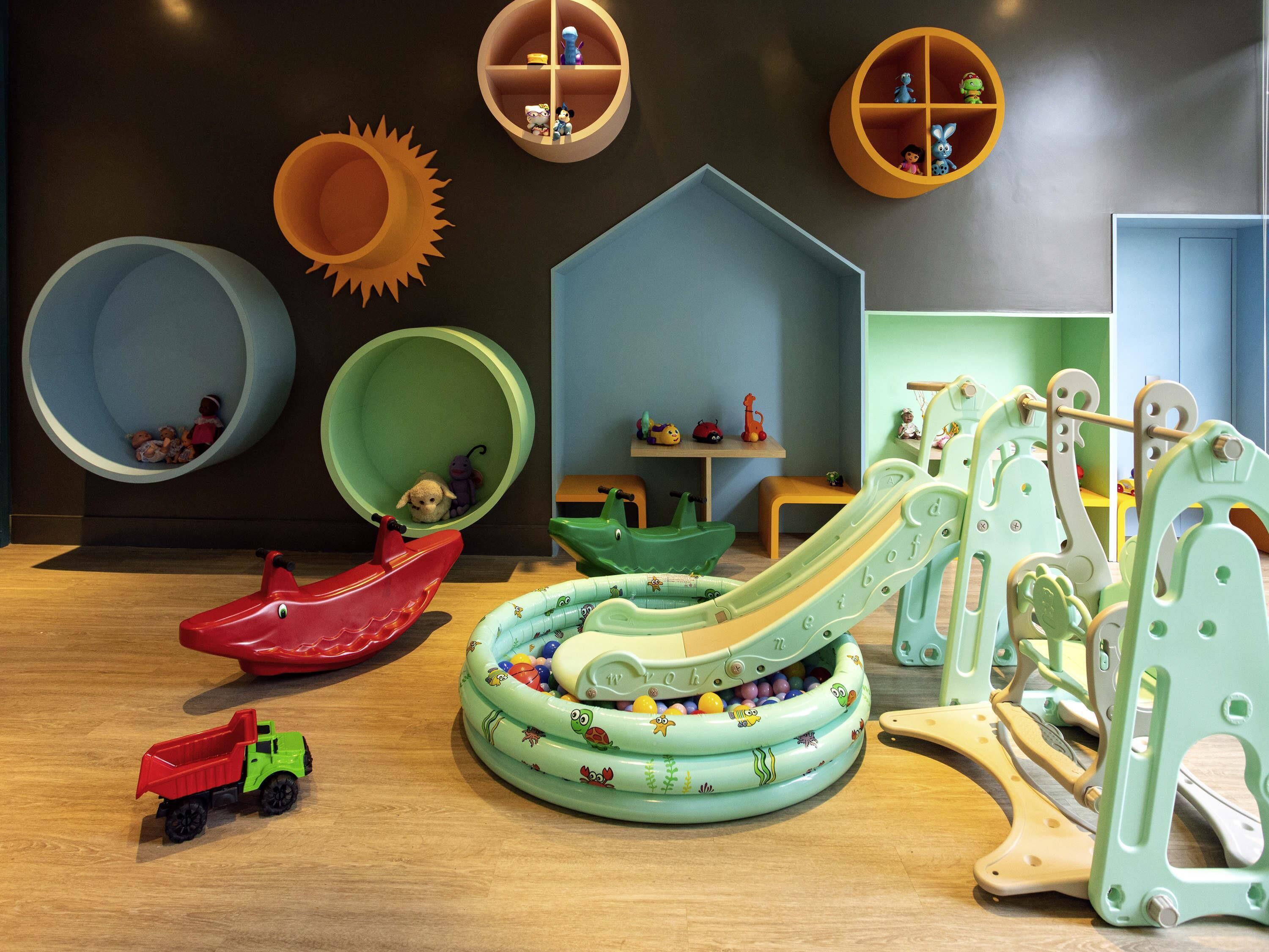 A play area with a slide, a climbing structure, and a ball pit.