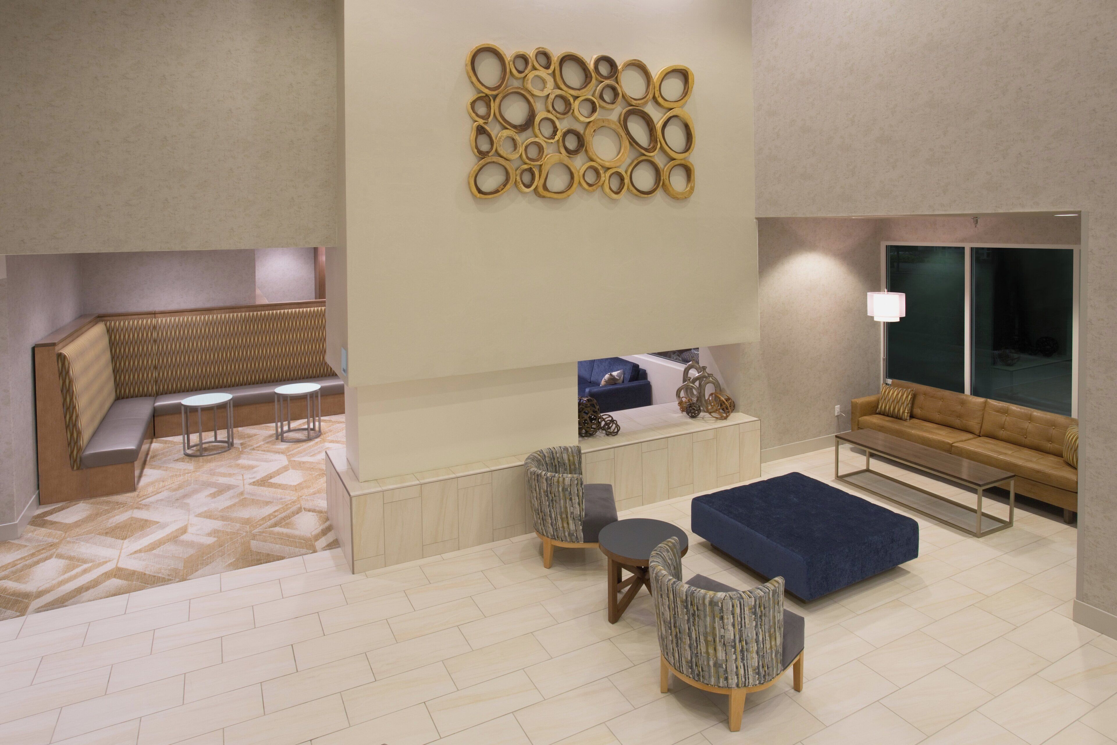En moderne lobby med siddeområde, reception og sofa.