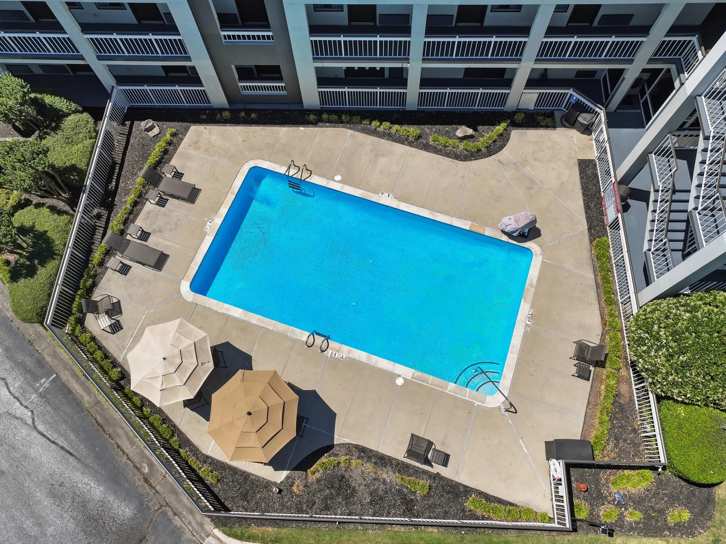 Una piscina al aire libre de temporada, sillones reclinables de piscina