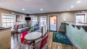 A modern interior with a bar area, seating, and a reception desk. - Quality Inn Glenpool - Tulsa (Glenpool)
