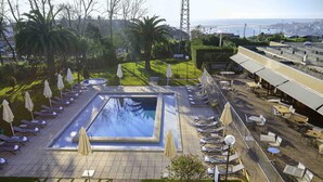 A rooftop pool area with sun loungers, a small pool, and a view of the ocean. - Novotel Porto Gaia (Vila Nova de Gaia)