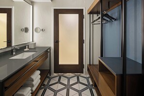 A modern bathroom with a double sink vanity, a mirror, a towel rack, and a shower area. - Oshkosh Marriott Waterfront Hotel & Convention Center (Oshkosh)
