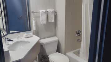 A modern bathroom with a sink, toilet, and shower.