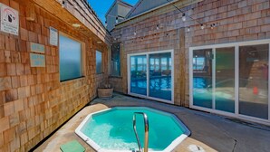 A wooden spa area with a 3ft depth pool, glass doors, and a sign indicating no glassware allowed in the pool area. - Embarcadero Resort Hotel & Marina (Newport)