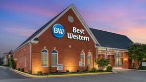 A hotel with a prominent 'BW Best Western' sign, a brick facade, and a clear sky.