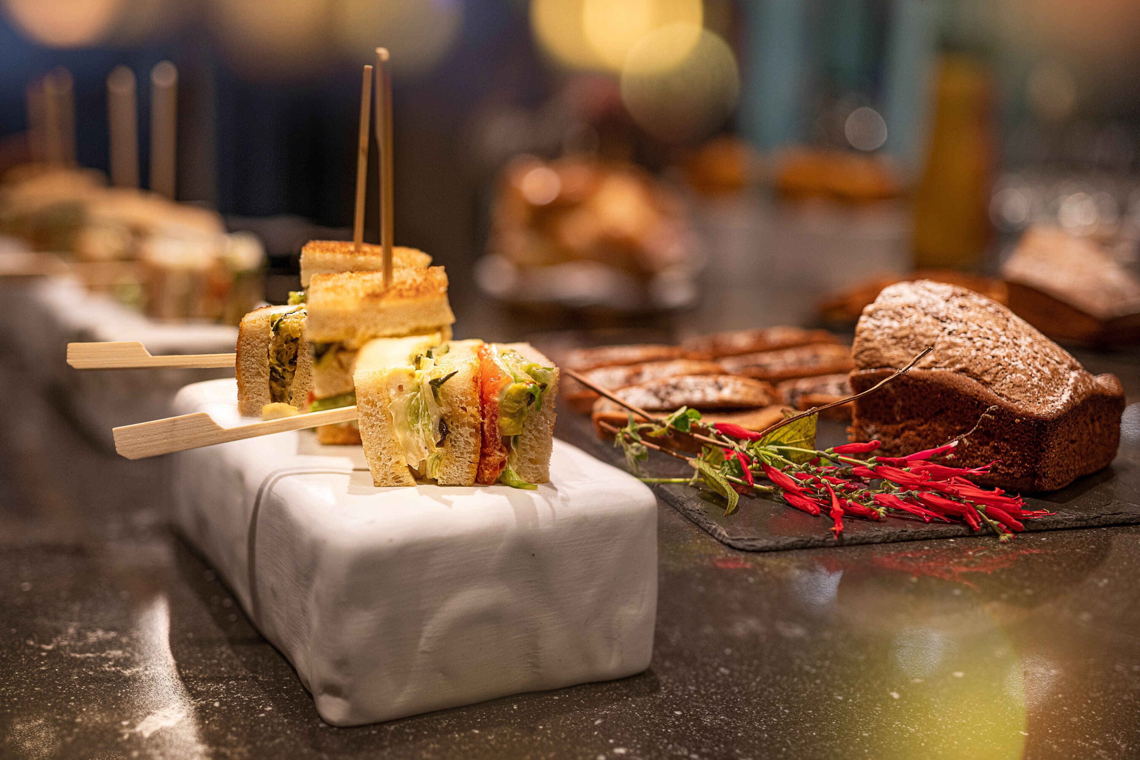A variety of sandwiches and pastries on a counter.