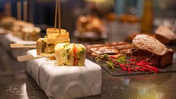A variety of sandwiches and pastries on a counter.