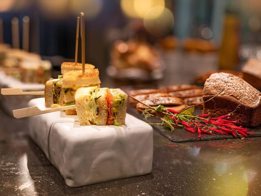 A variety of sandwiches and pastries on a counter.