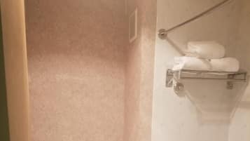 A bathroom with a toilet, a bathtub, and a shower.