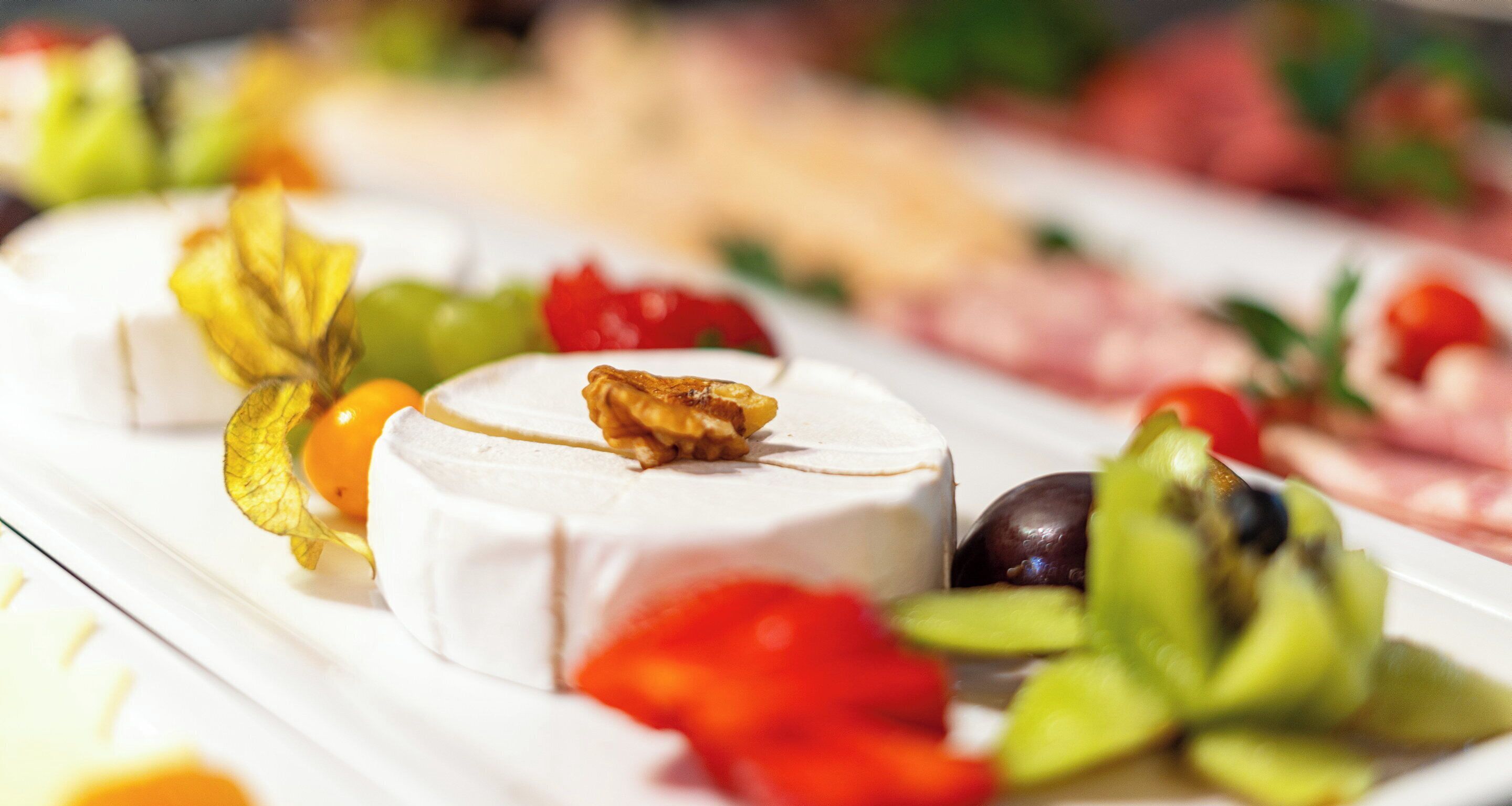 A cheese platter with various accompaniments.