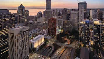 A cityscape with high-rise buildings, a waterfront, and a busy highway.