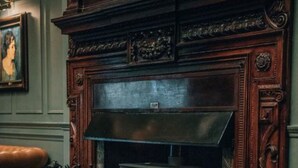 A room with a fireplace, a plaid chair, and a framed picture on the wall. - Blackwell Grange Hotel (Darlington)