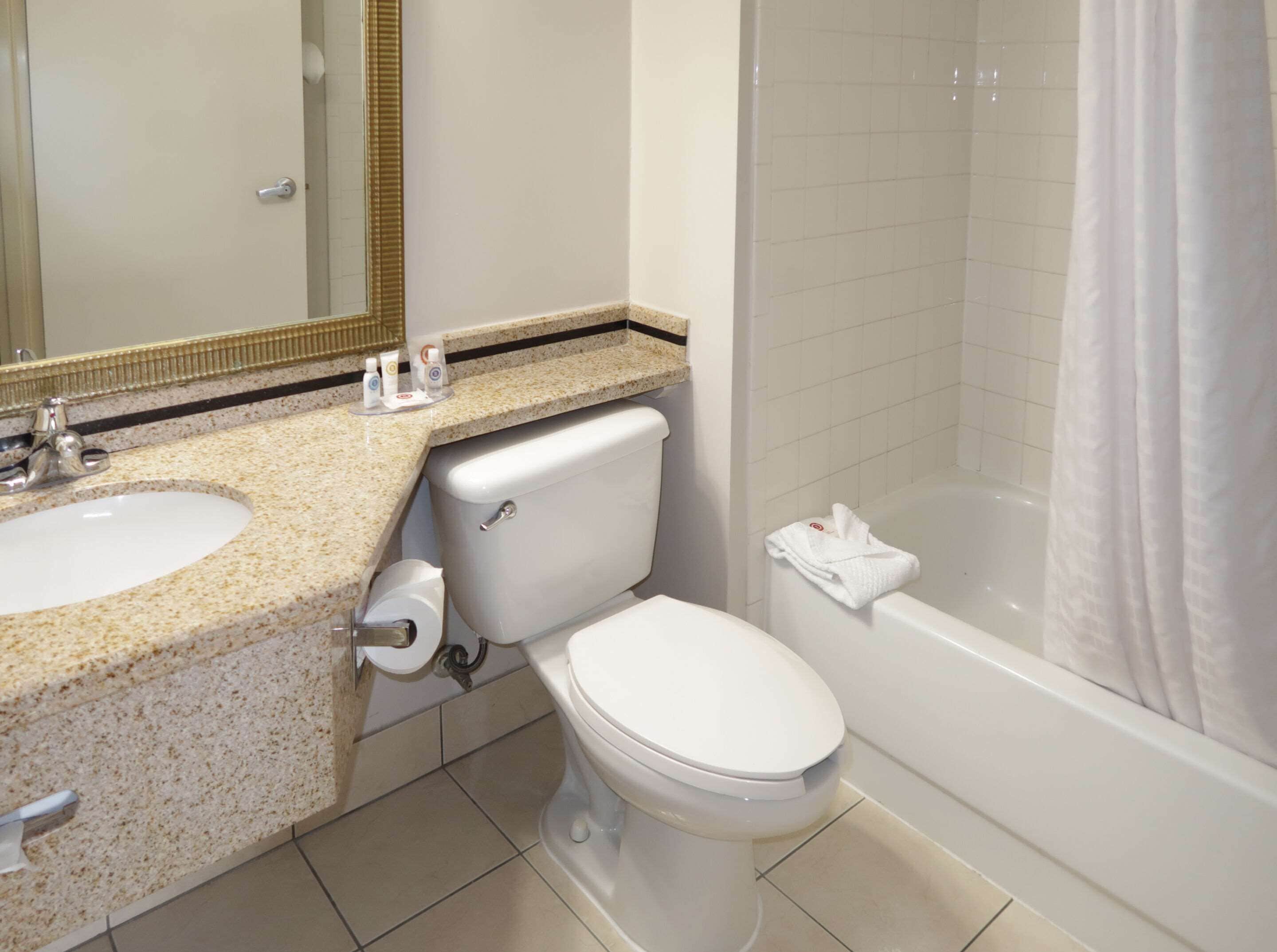 A bathroom with a sink, toilet, and bathtub.