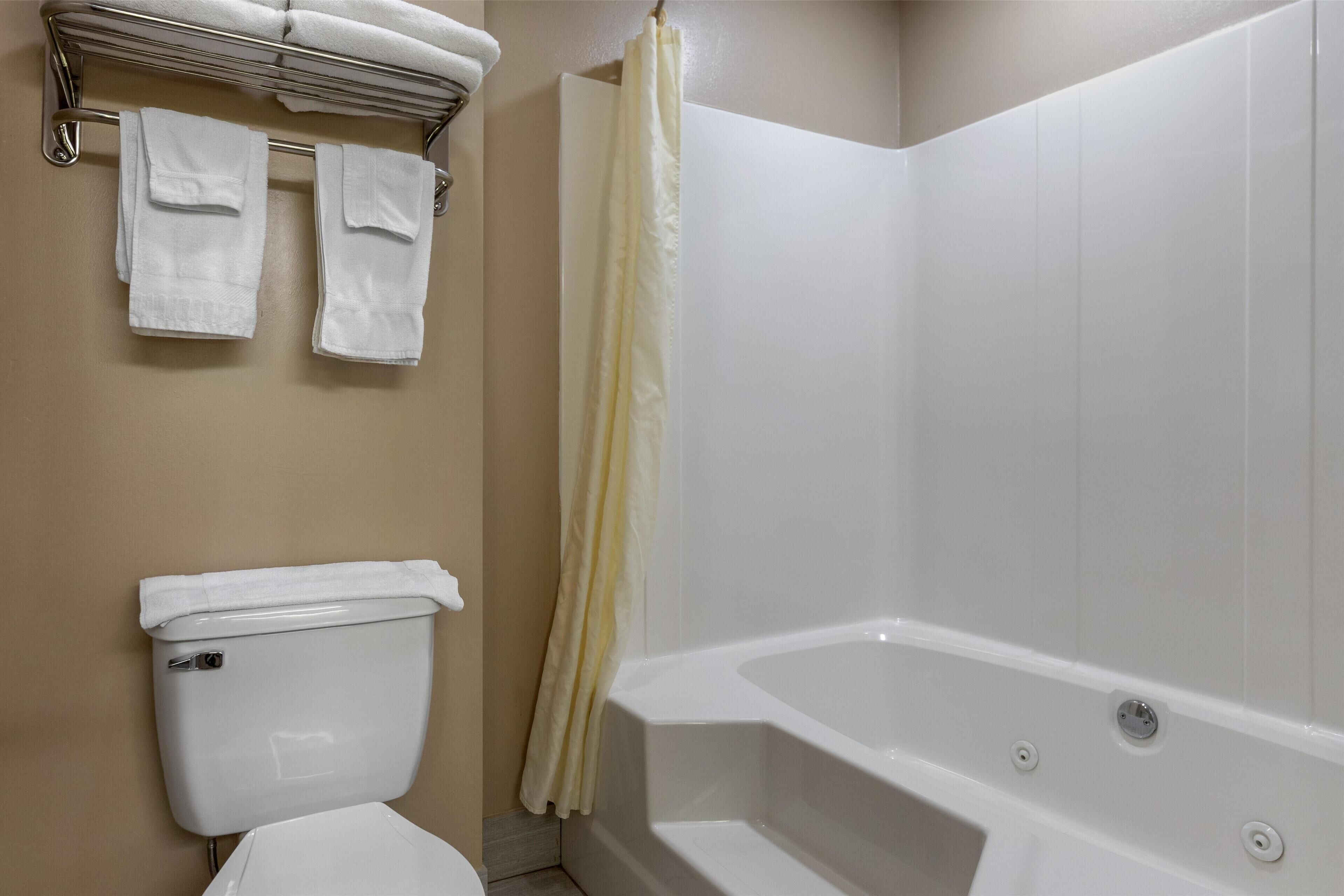 suite, 1 king bed, non smoking, refrigerator & microwave (dining table) | bathroom | combined shower/bathtub, free toiletries, hair dryer, towels