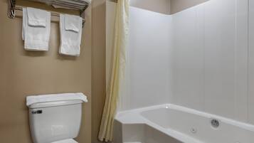 A bathroom with a toilet, a bathtub, and a towel rack with two towels.