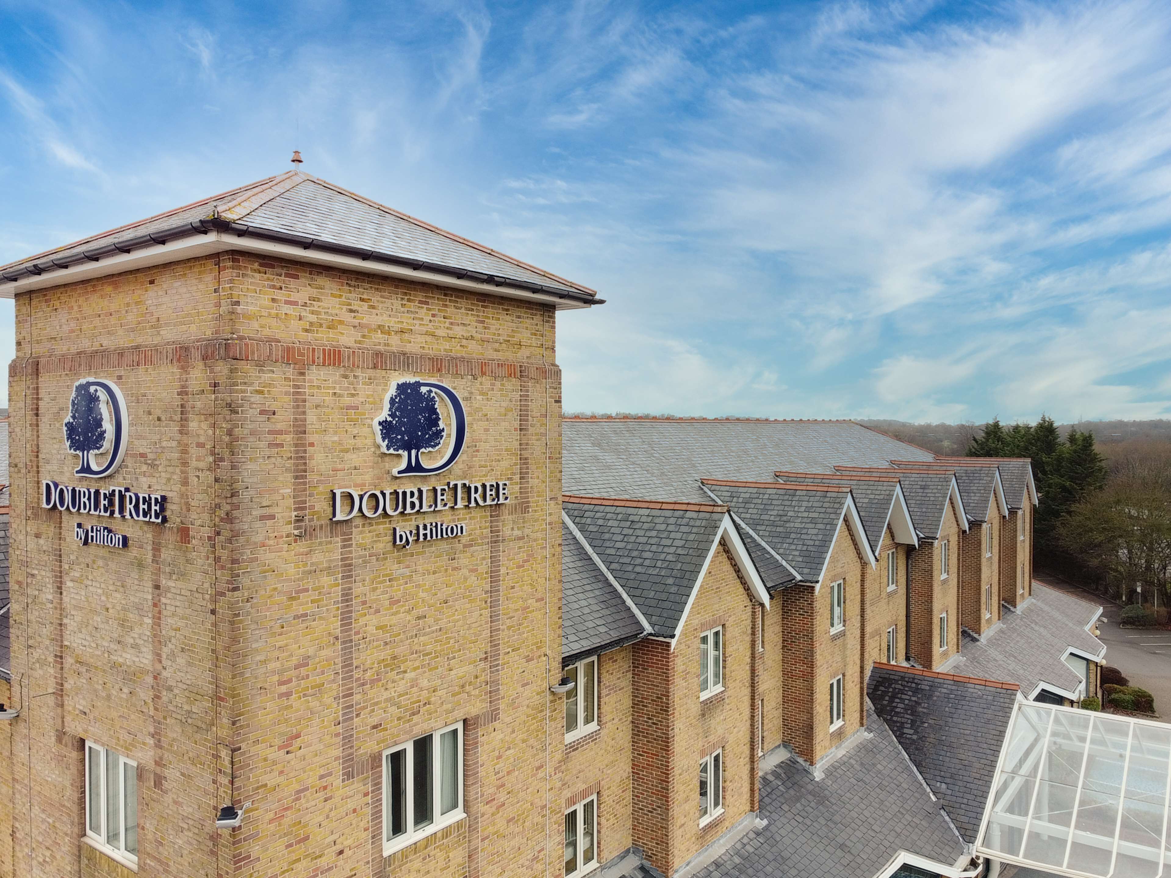 A DoubleTree hotel with a brick facade and a distinctive logo.