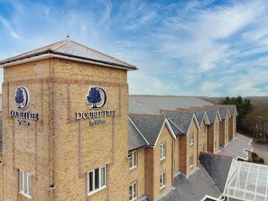 A DoubleTree hotel with a brick facade and a distinctive logo. - DoubleTree by Hilton London Elstree (Borehamwood)