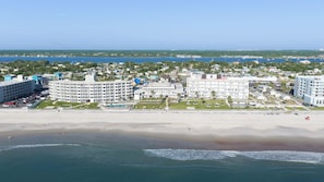 A coastal hotel with multiple buildings, a beachfront, and a clear view of the sea. - Perry's Ocean Edge Resort (Daytona Beach Shores)